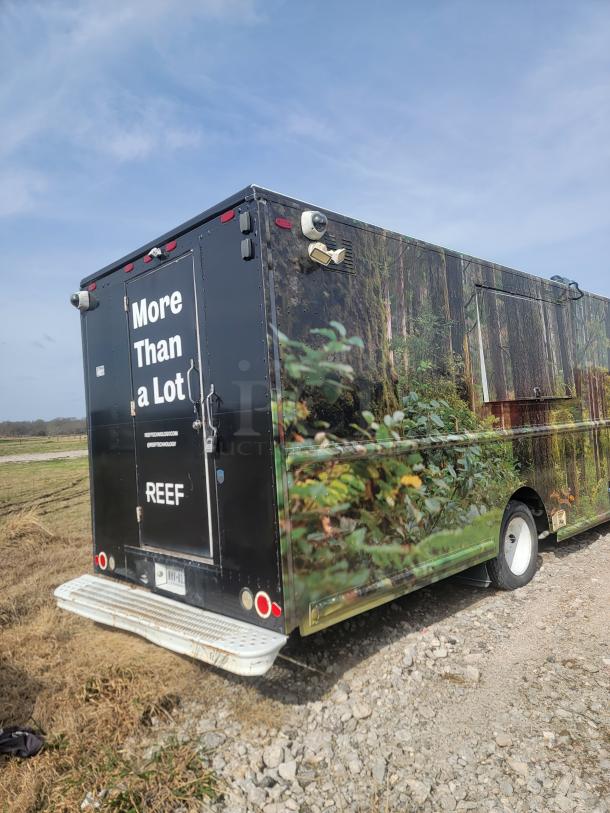 Food truck with nature-themed wrap, marked "More Than a Lot" and "REEF." Equipped with security cameras. Good exterior condition.