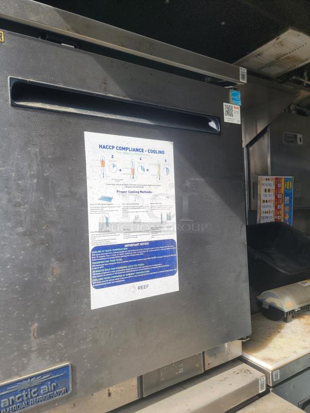 Commercial refrigeration unit with HACCP compliance guidelines on the door. Arctic Air branding visible. Used condition.