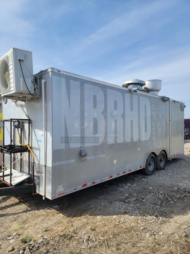 Mobile food trailer with "NBRHD Kitchens" branding, metal exterior, rooftop vent, mounted air unit, dual axles, used condition.