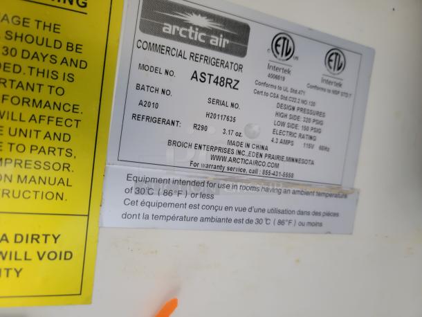 Arctic Air Commercial Refrigerator, Model AST48RZ, refrigerant R290, electric rating 115V, 4.3 amps. Condition: Information label visible.
