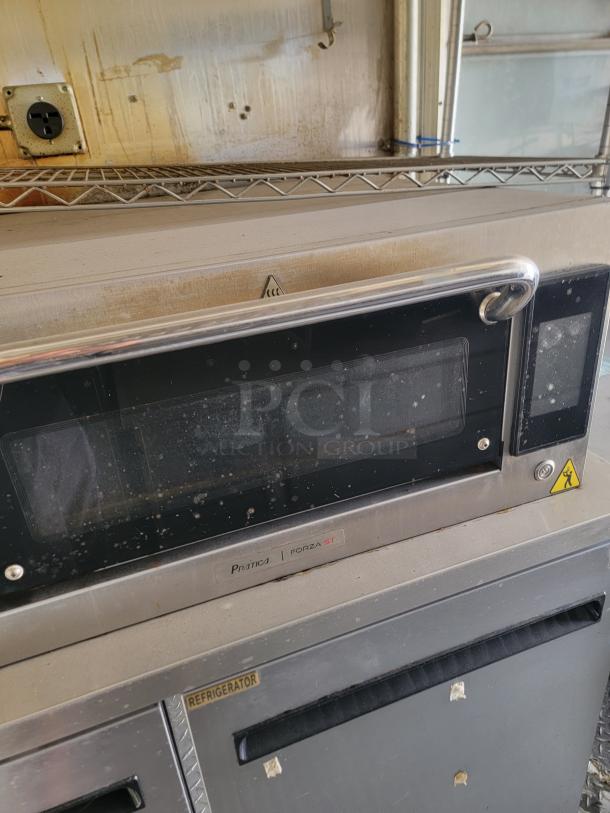 Pratica Forza STi commercial microwave with visible wear, stainless steel, featuring a front control panel and labeled "Refrigerator."