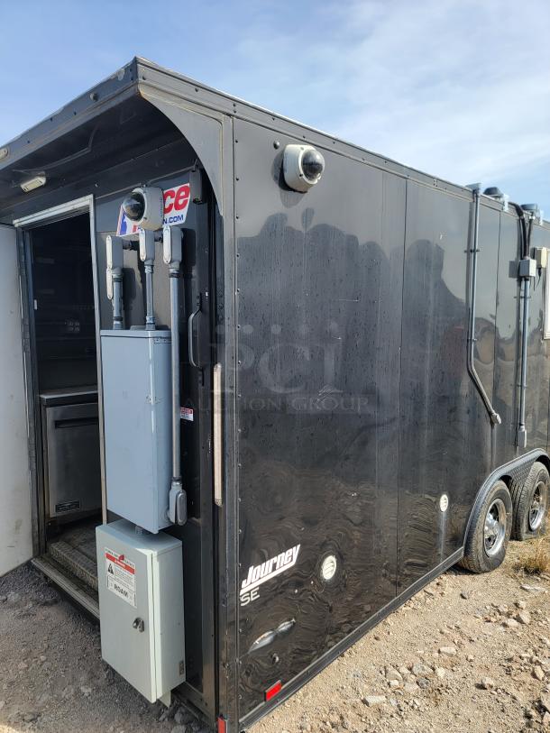 Black Journey SE trailer with dual axles, visible CCTV cameras, and power boxes. Appears used, outdoor location.