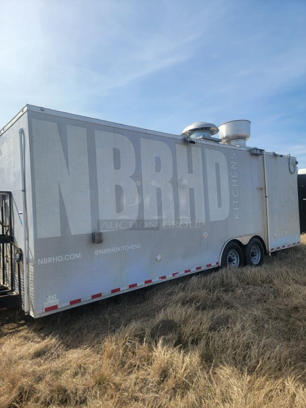 Mobile kitchen trailer with "NBRHD Kitchens" branding, side vents, and rear door. White exterior, good condition. Visible website URL.