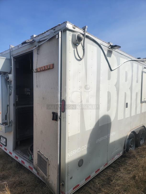 Food truck trailer with "NBRHD" branding, side entry open, visible hooks, dual wheels, online handles @NBRHDKITCHENS, needs cleaning.