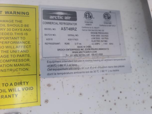 Arctic Air Commercial Refrigerator model AST48R2 label showing model number, refrigerant type R290, and electrical specs.
