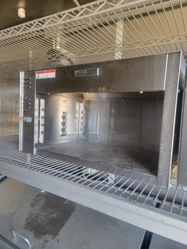 Vulcan commercial stainless steel oven, used, with visible wear and warning labels, suitable for high-capacity cooking.