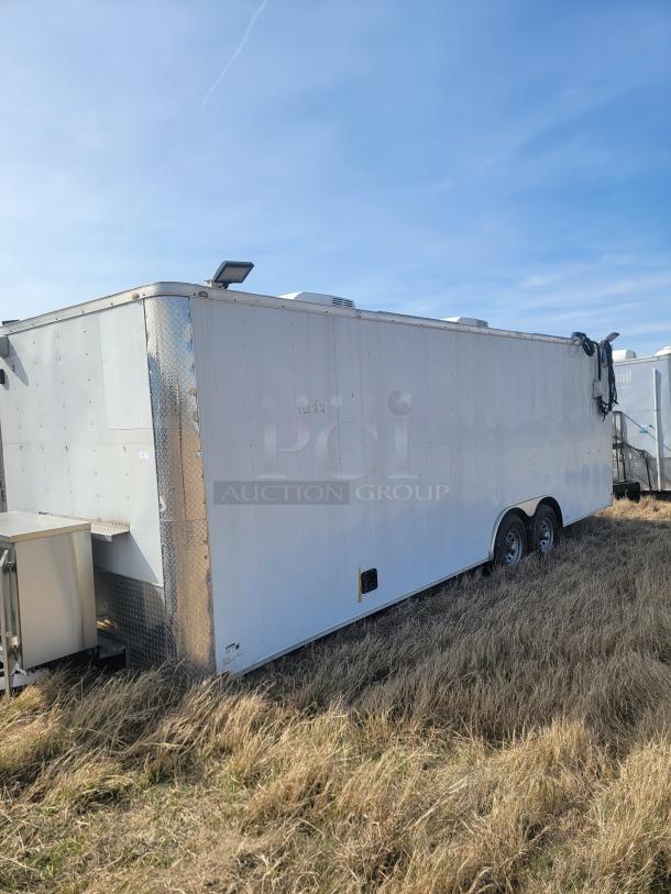 White enclosed utility trailer with dual axles, in fair condition. Features diamond plating and roof vents. No visible branding.