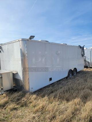 White enclosed utility trailer with dual axles, in fair condition. Features diamond plating and roof vents. No visible branding.