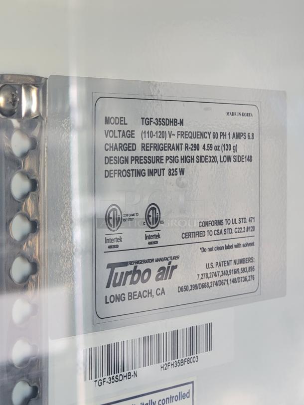 Turbo Air industrial refrigerator label indicating model TGF-35SDHB-N, voltage 110-120V, refrigerant R-290, and defrosting input 825W. Made in Korea.