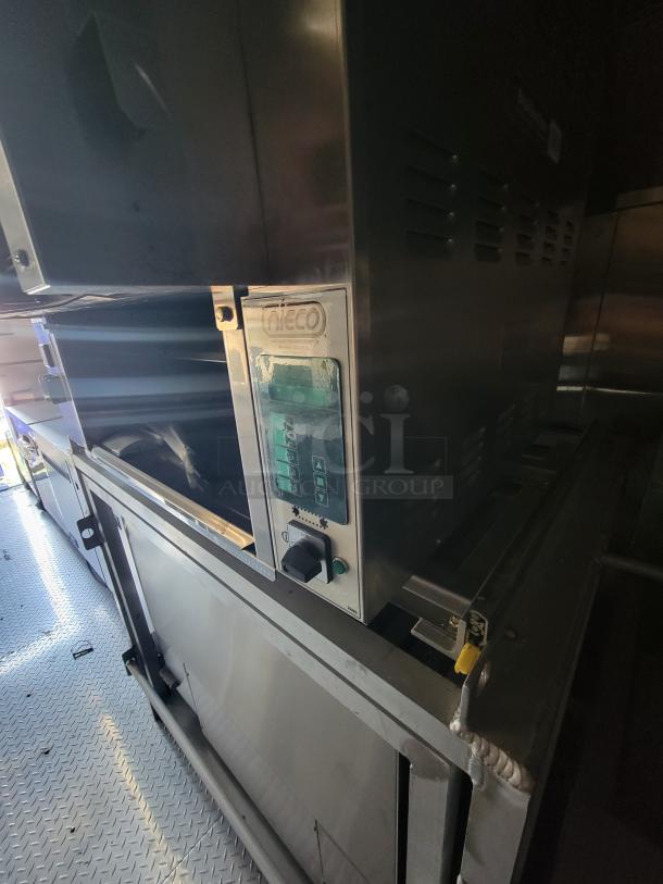 Nieco automatic broiler in metal finish, featuring control panel with buttons for operation. Appears in good condition.