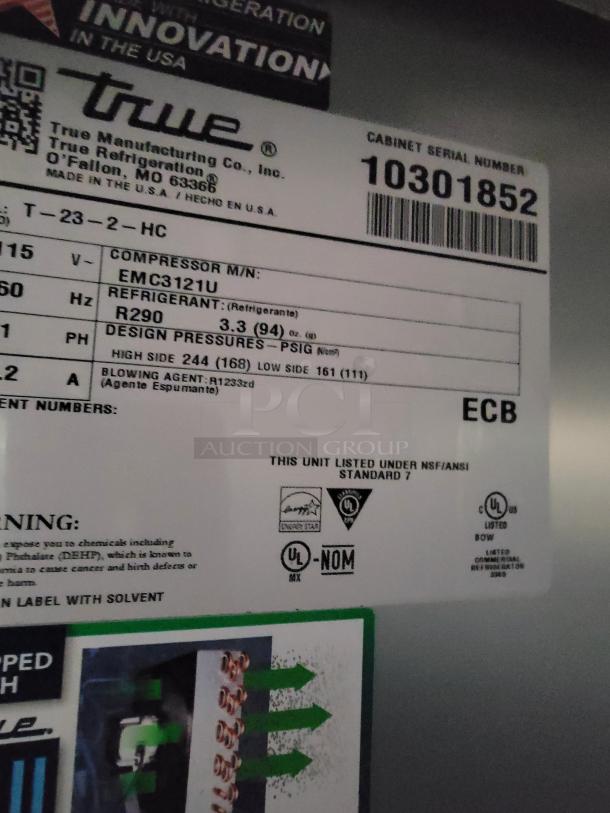 True Manufacturing refrigeration unit label showing model T-23-2-HC, compressor EMC3121U, refrigerant R290, serial no. 10301852, UL certified.
