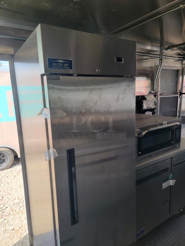 Arctic Air commercial freezer, stainless steel, upright model, visible label, minor wear, ideal for commercial kitchens.