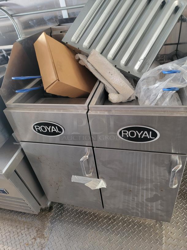 Stainless steel Royal double-door kitchen cabinet with labels, surface scratches, and handle markings. Includes compartment items.