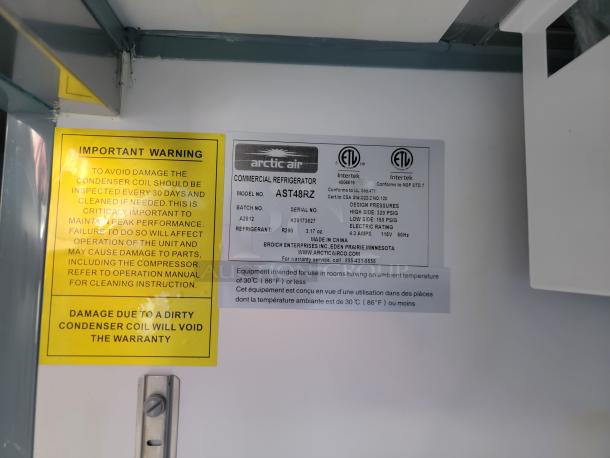 Arctic Air commercial refrigerator model AST48RZ label. Includes maintenance warning and specifications for temperature and pressure.
