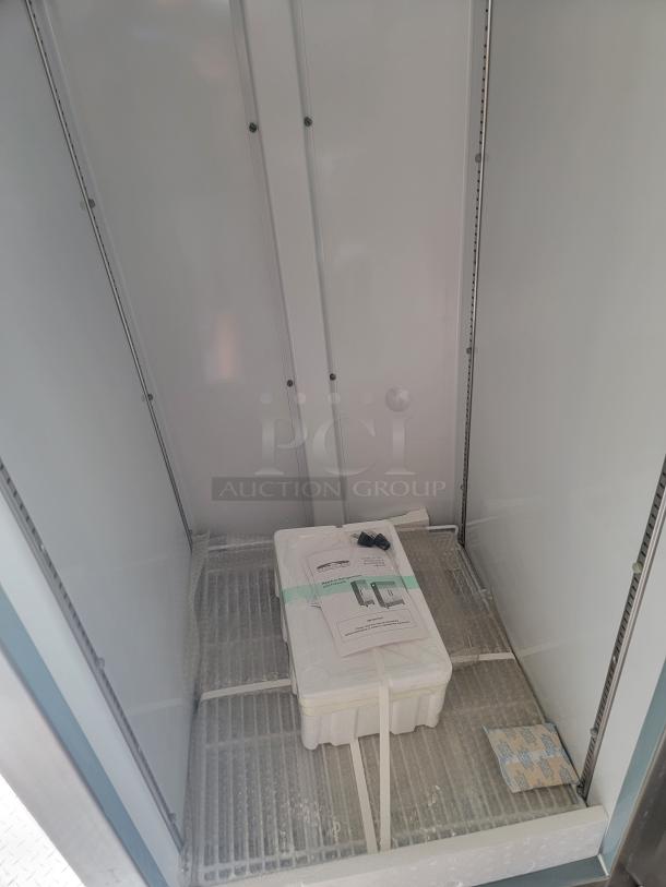 Industrial storage unit interior with metal shelving, foam padding, and a boxed package labeled "User Manual." Ideal for secure storage.