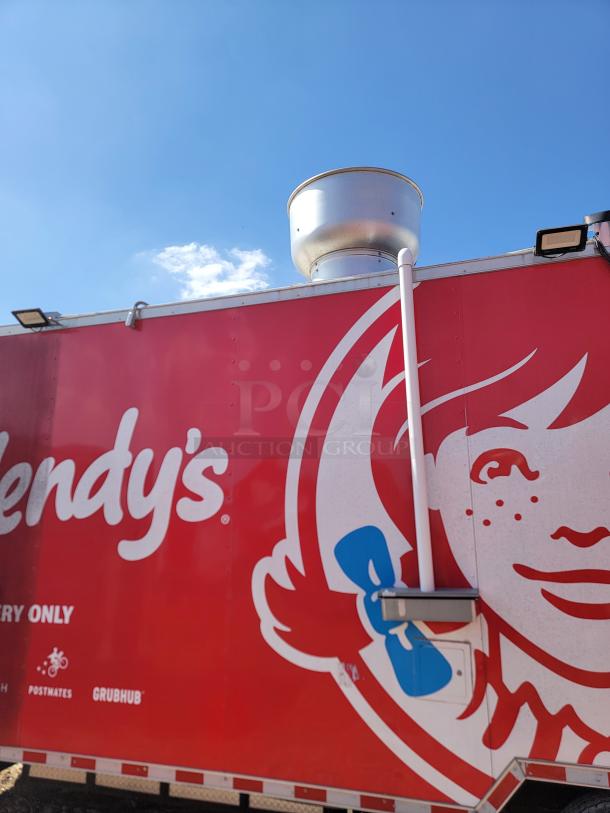 Wendy's promotional trailer with red branding, featuring the iconic logo and equipped with a silver exhaust vent on top.