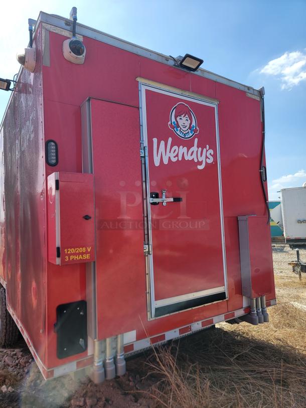 Red Wendy's mobile trailer with logo, features a 120/208V 3-phase electrical panel. Outdoor condition, steel construction.