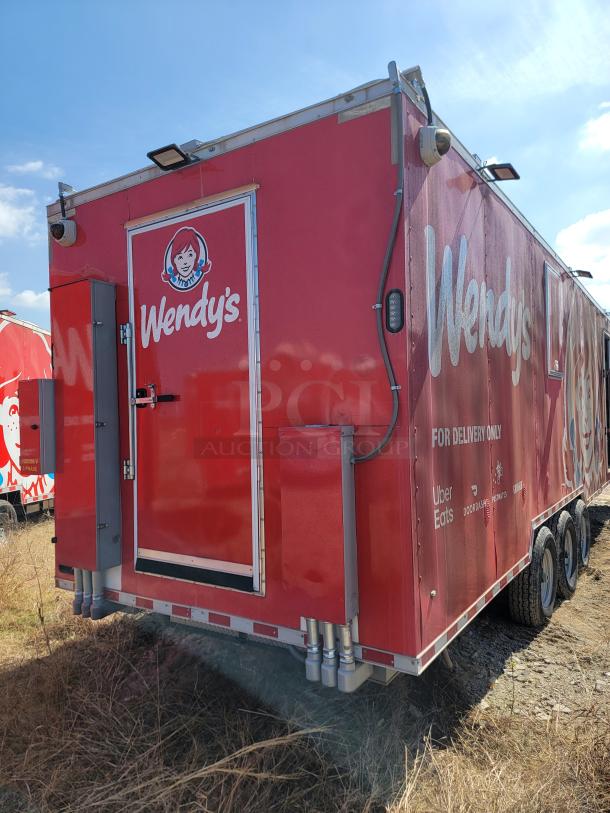 Red Wendy's mobile kitchen trailer with logo and delivery service branding. Good condition, suitable for delivery operations.