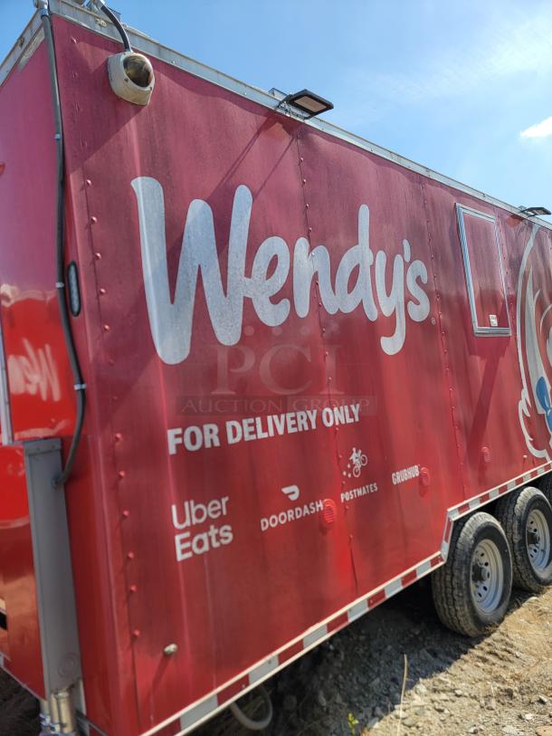 Red Wendy's mobile kitchen trailer, "For Delivery Only" with Uber Eats, DoorDash, Postmates, and Grubhub logos.