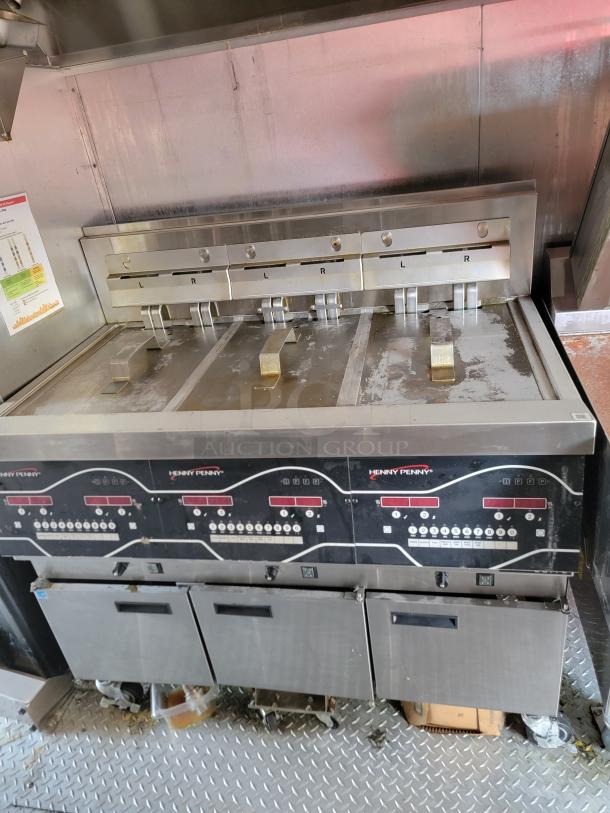 Henny Penny commercial fryer with control panel. Features multiple fry baskets and compartments. Used condition.