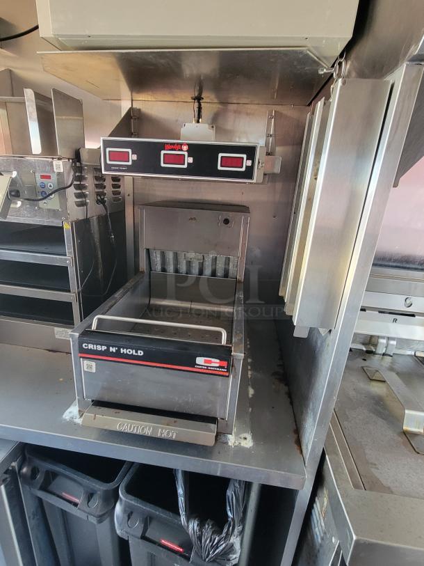 Countertop Crisp N' Hold food warmer by Carter-Hoffmann. Features digital controls, "Wendy's" logo, and "Caution Hot" label. Good condition.