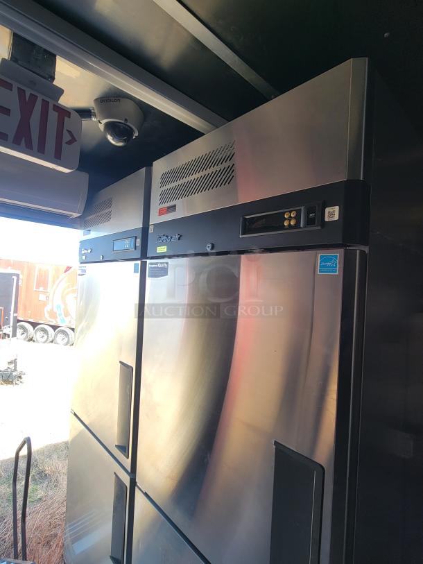 Stainless steel commercial refrigerator with top vents, digital display, and quality certification sticker.