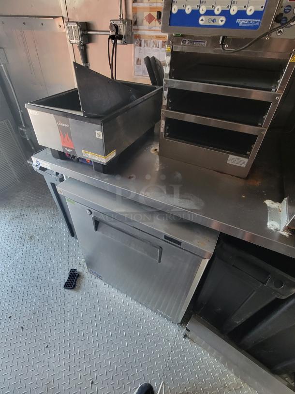 Commercial kitchen equipment featuring a Nemco Cayenne food warmer with visible controls and branding.