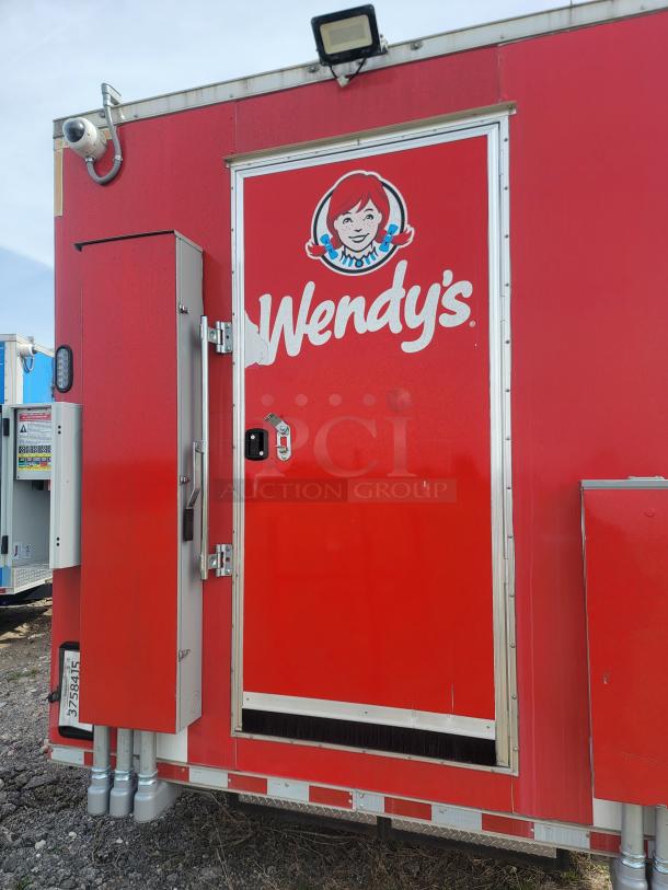 Red mobile unit with Wendy's logo, side door, control boxes, and camera attached. Condition appears used.