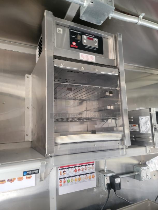 Stainless steel food warming cabinet with digital controls and Wendy's branding, featuring multiple shelves in excellent condition.