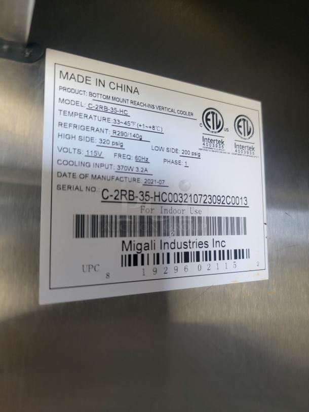 Label on Migali Industries vertical cooler, model C-2RB-35-HC, made in China, shows specs and ETL certification.