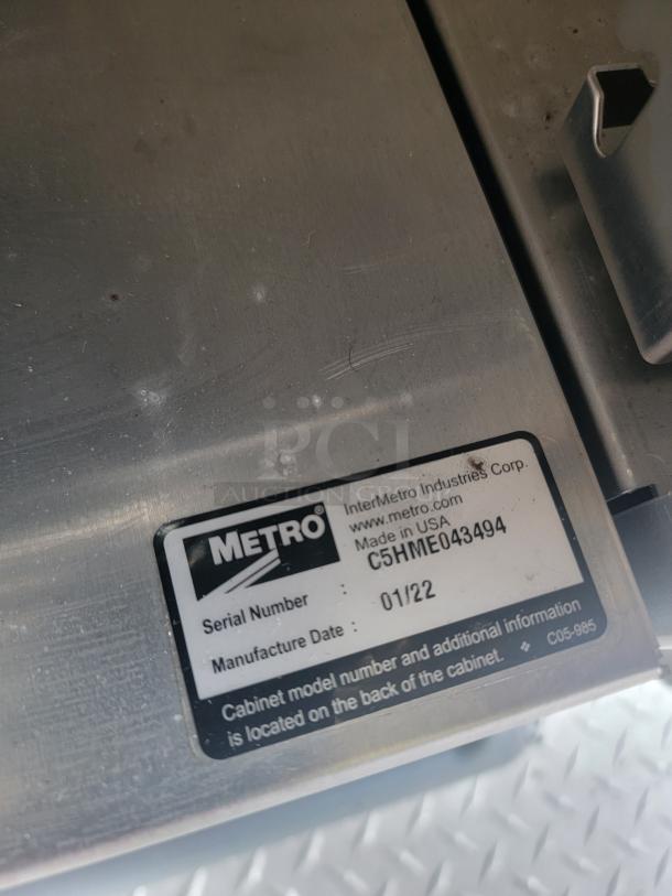 Metal surface with a Metro label showing serial number C5HME043494 and manufacture date 01/22.