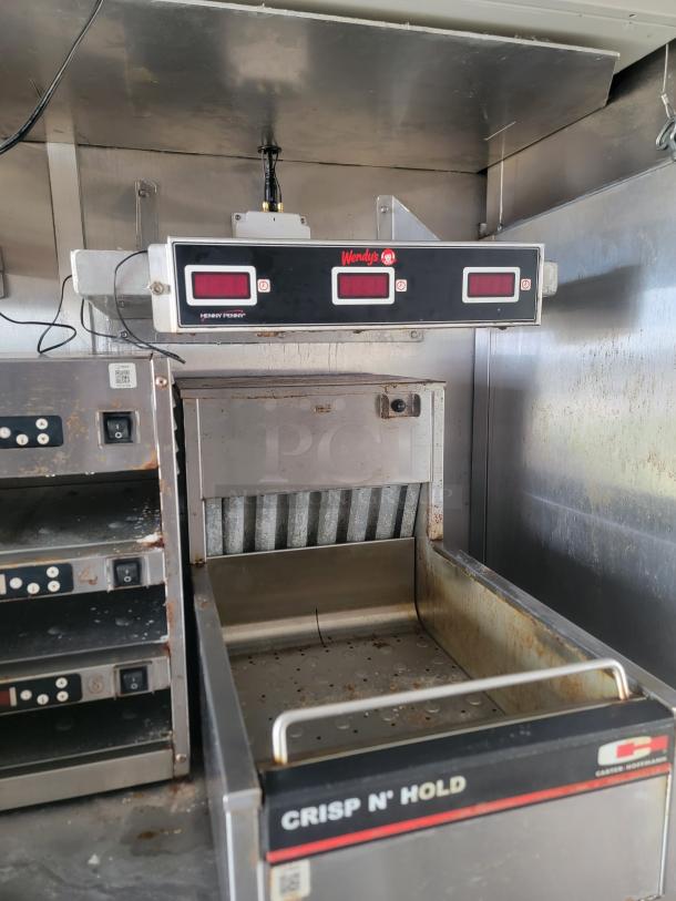 Commercial kitchen equipment featuring a Crisp N' Hold unit and digital timer, branded Wendy's by Henny Penny, in used condition.