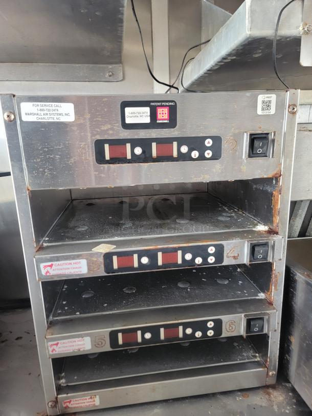Commercial countertop warming unit, Marshall Air Systems, with six shelves, visible rust and wear, service labels attached.