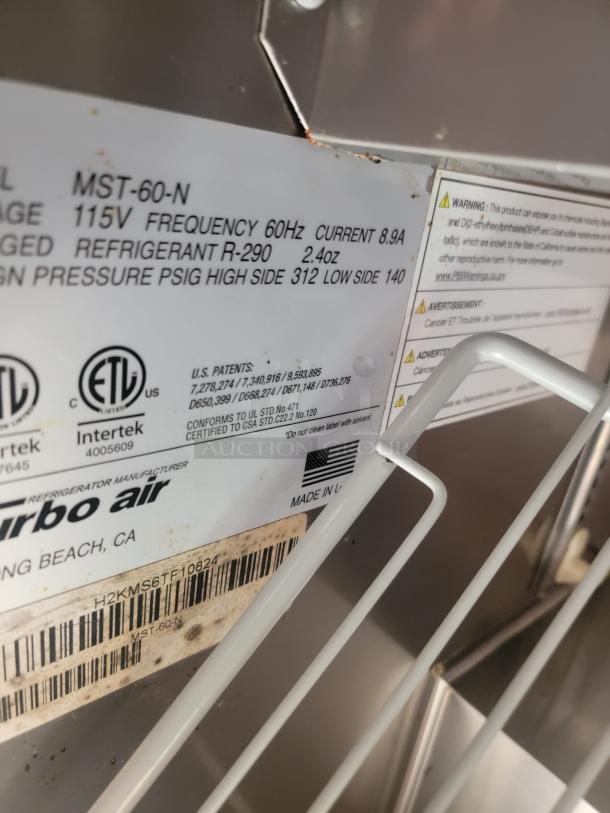 Turbo Air MST-60-N label showing 115V, 60Hz, 8.9A, R-290 refrigerant. Made in USA. Visible rust, auction item.