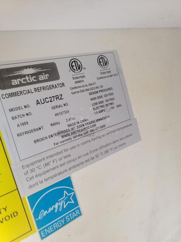 Arctic Air commercial refrigerator label showing model AUC27RZ, serial number H9127324, Energy Star certified.