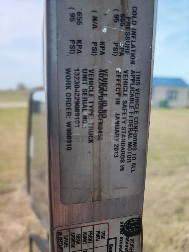 Vehicle compliance label, detailing cold inflation pressure, vehicle type (truck), unit serial number 1323042309810, and work order W908910.