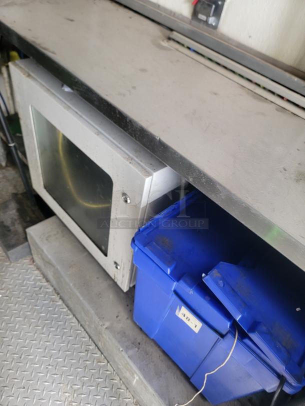 Stainless steel workbench with storage, featuring a built-in microwave and blue plastic bin marked "48-1." Slightly worn condition.
