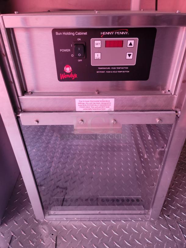 Henny Penny bun holding cabinet with Wendy's branding, digital control panel, and power switch. Good condition.