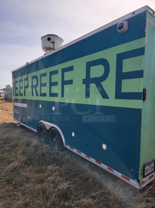 Large blue and green trailer with "REEF" logo, dual axle, rooftop equipment, and Texas license plate. Good condition.