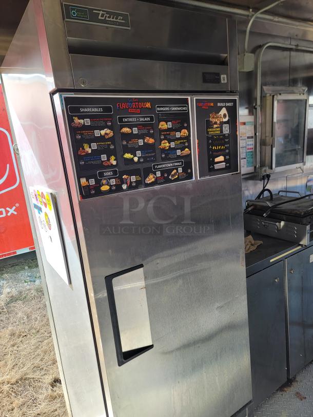 True freezer with visible Flavortown menu and build sheet. Stainless steel, used condition. Ideal for commercial kitchens.