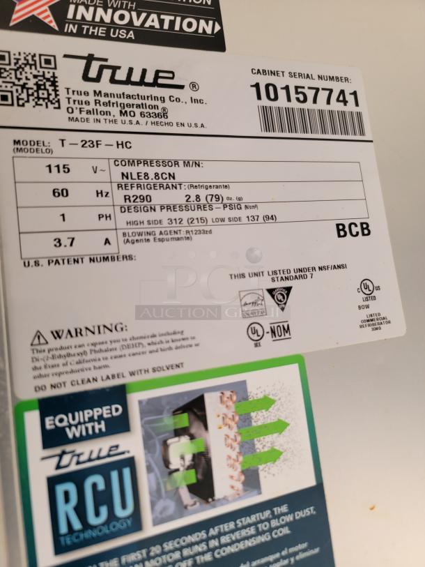 True T-23F-HC commercial refrigerator label showing model, refrigerant type R290, compressor info, and safety warnings.