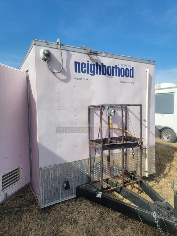 Pink mobile kitchen trailer with "Neighborhood Kitchens" branding. Features include a security camera, ventilation, and diamond plate trim.