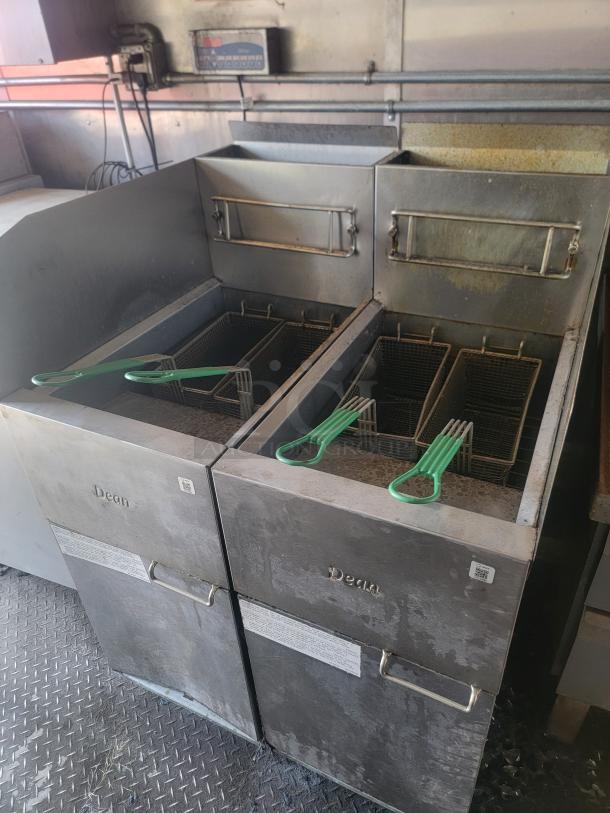 Dean commercial deep fryer set, dual units, stainless steel, four fry baskets with green handles, used condition, visible wear.