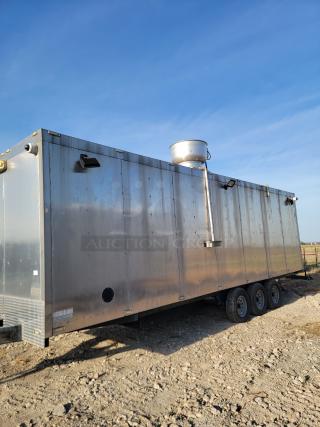 Large silver metal trailer with ventilation system on gravel. Triple-axle wheels, visible wear. Suitable for conversion or transport.