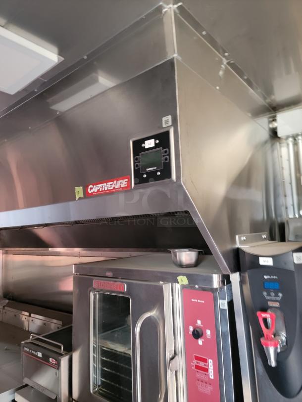 Commercial kitchen setup featuring a CaptiveAire vent hood and a Blodgett oven, both in stainless steel and good condition.