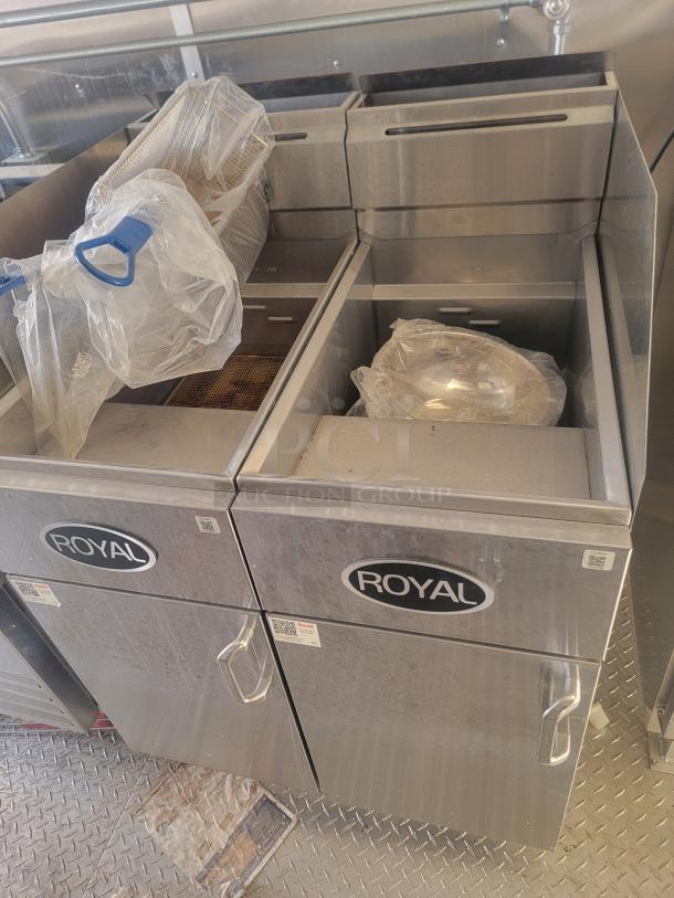 Royal deep fryers, stainless steel, dual units with baskets, used condition. Model labels visible.