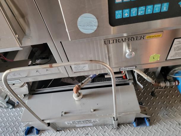 Ultrafryer UltraGold commercial fryer, stainless steel finish, control panel visible, labeled "Drain Lever," in used condition.