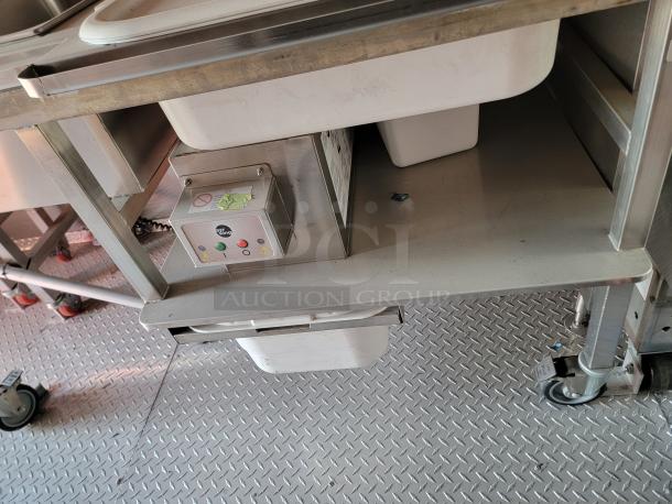 Stainless steel kitchen cart with a built-in electric control panel, plastic bins, and caster wheels. Good condition.