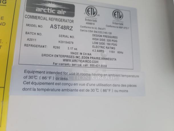 Arctic Air commercial refrigerator label showing model AST48RZ, refrigerant R290, and design pressures.