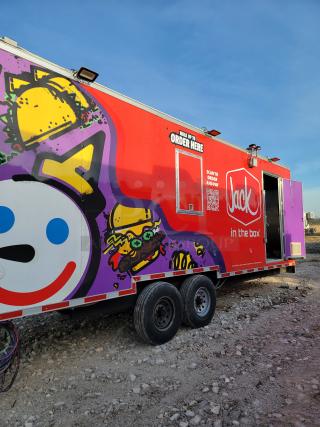 Jack in the Box food truck with vibrant taco and burger graphics, order window, and QR code for ordering.